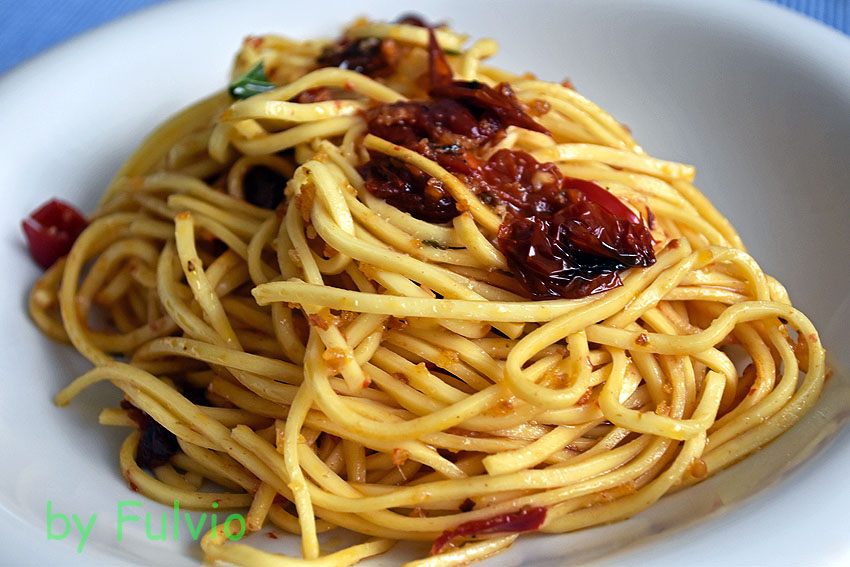 Spaghetti with garlic, oil and chilli pepper with confit cherry tomatoes